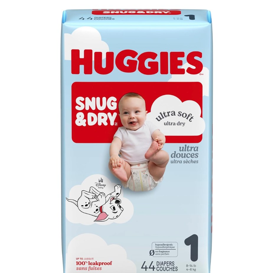 Huggies Snug & Dry Diapers — diaper pack on a changing table, shown at scale